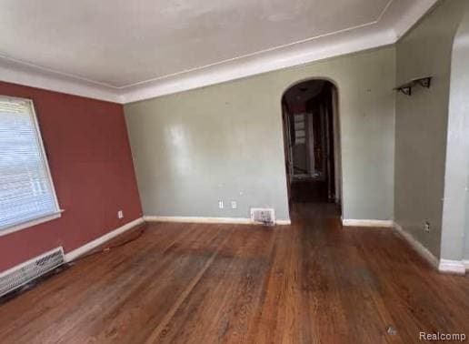 15421 Park Grove St, Detroit, MI 48205 - empty room with arched walkways, wood finished floors, and crown molding