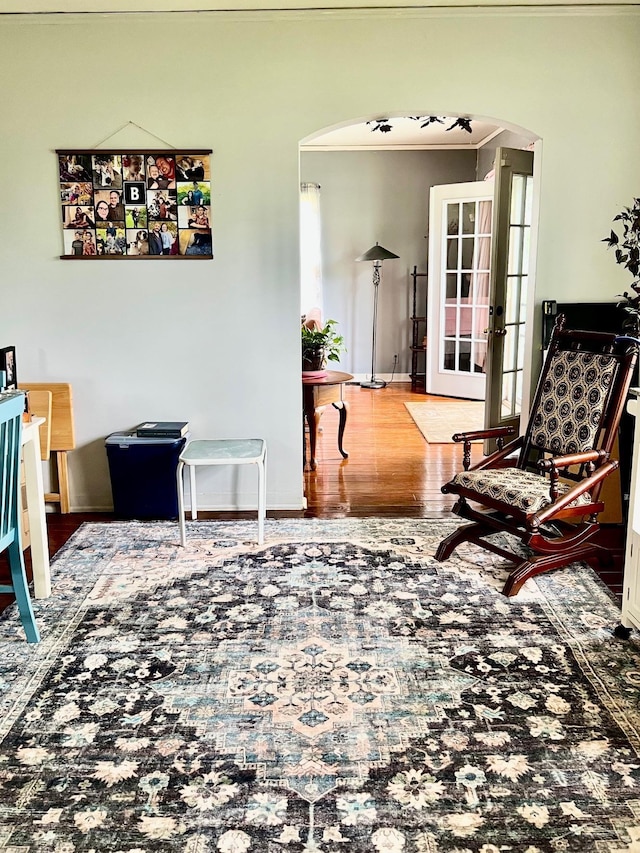 1202 N Fayette St, Saginaw, MI 48602 - sitting room featuring arched walkways, wood finished floors, and french doors