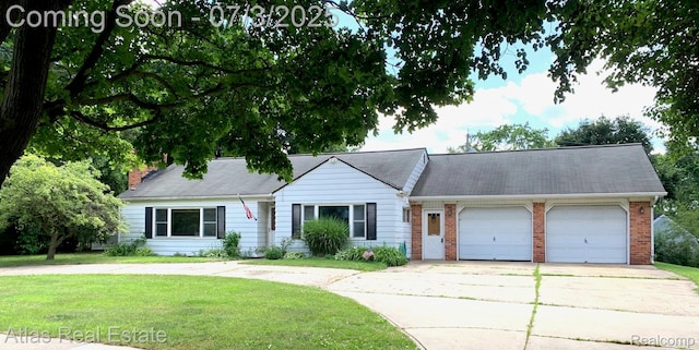6201 S Main St, Clarkston, MI 48346 - view of front facade featuring an attached garage, driveway, a front lawn, and brick siding
