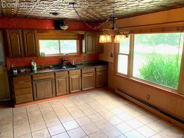 6201 S Main St, Clarkston, MI 48346 - kitchen with baseboard heating, an ornate ceiling, dark countertops, hanging light fixtures, and brown cabinets