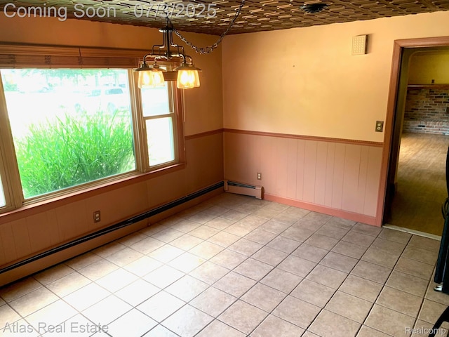 6201 S Main St, Clarkston, MI 48346 - unfurnished room with a baseboard heating unit, a wainscoted wall, light tile patterned floors, a chandelier, and an ornate ceiling