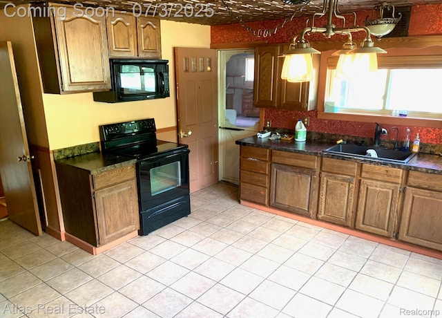 6201 S Main St, Clarkston, MI 48346 - kitchen with black appliances, dark countertops, brown cabinets, and light tile patterned flooring