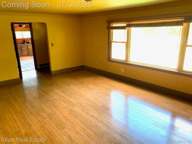 6201 S Main St, Clarkston, MI 48346 - spare room featuring light wood-style flooring and baseboards