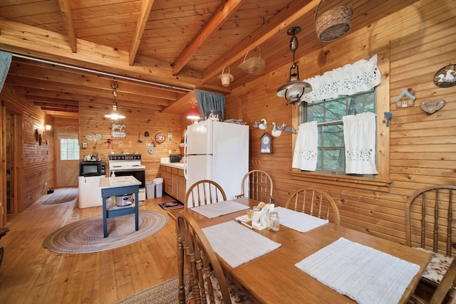 5680 E Shores Dr, Michigan, MI 49411 - dining room featuring wood walls, light wood-type flooring, and a wood ceiling with exposed beams