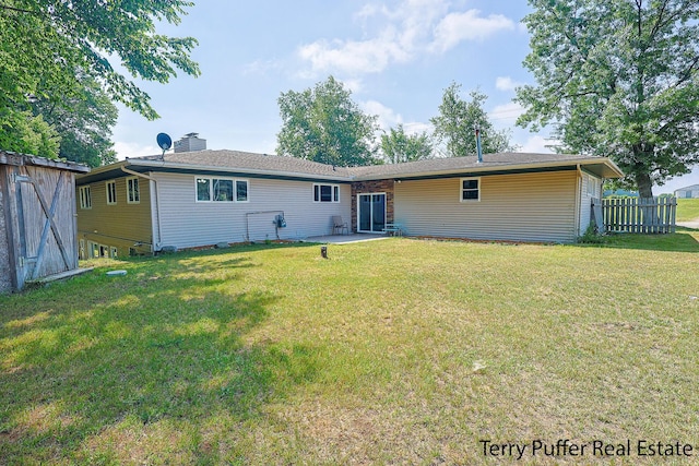 721 17 Mile Rd, Kent City, MI 49330 - rear view of house with a patio and a chimney