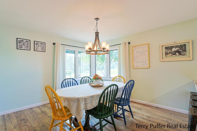 721 17 Mile Rd, Kent City, MI 49330 - dining space featuring a chandelier and wood finished floors