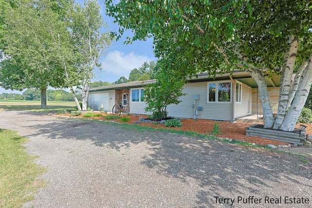 721 17 Mile Rd, Kent City, MI 49330 - view of front of property featuring gravel driveway and a garage