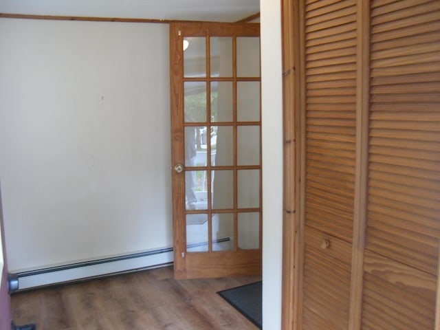 812 N Rath Ave, Ludington, MI 49431 - detailed view of a baseboard heating unit and wood finished floors