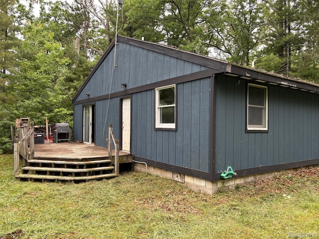 1185 E Hughes Lake Rd, Rose City, MI 48654 - view of side of home with a deck and a lawn