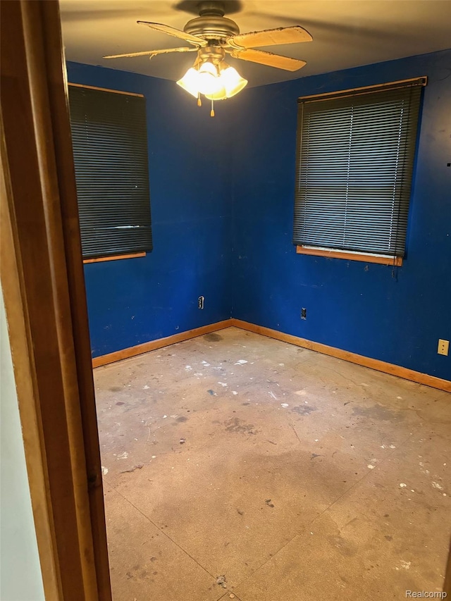 1185 E Hughes Lake Rd, Rose City, MI 48654 - unfurnished room with ceiling fan and concrete flooring