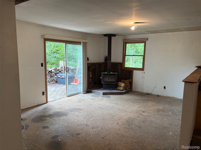 1185 E Hughes Lake Rd, Rose City, MI 48654 - unfurnished living room featuring a wood stove