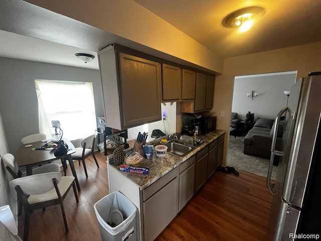16816 Pinehurst St, Detroit, MI 48221 - kitchen featuring freestanding refrigerator, dark wood finished floors, black microwave, and light stone counters