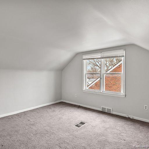 19405 Pierson St, Detroit, MI 48219 - additional living space featuring lofted ceiling and carpet flooring