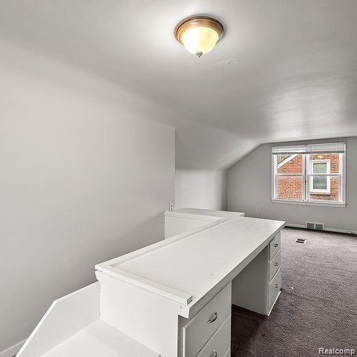 19405 Pierson St, Detroit, MI 48219 - additional living space with vaulted ceiling and dark carpet