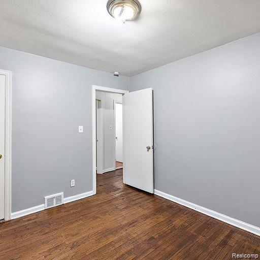 19405 Pierson St, Detroit, MI 48219 - empty room with baseboards and wood finished floors