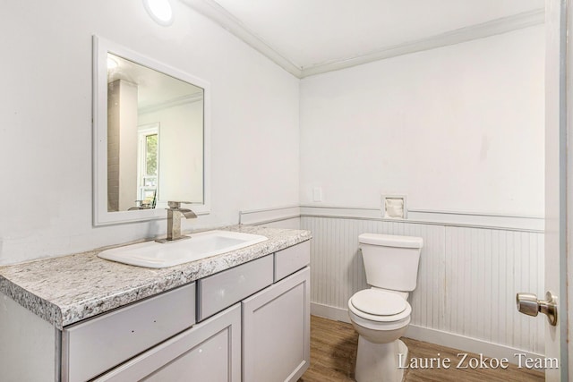 1101 White Ave NW, Grand Rapids, MI 49504 - bathroom with vanity, wood finished floors, wainscoting, and ornamental molding