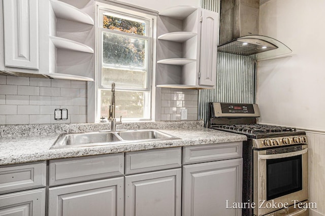 1101 White Ave NW, Grand Rapids, MI 49504 - kitchen with open shelves, stainless steel gas stove, range hood, and white cabinetry