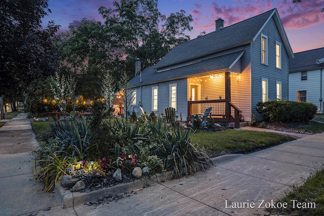 1101 White Ave NW, Grand Rapids, MI 49504 - view of front of property featuring a chimney, a porch, and a shingled roof