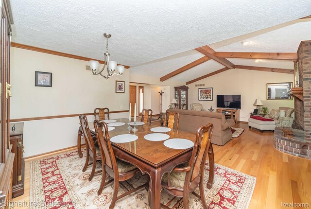 25759 Hunt Club Blvd, Farmington, MI 48335 - dining room with light wood-style flooring, a textured ceiling, and a chandelier