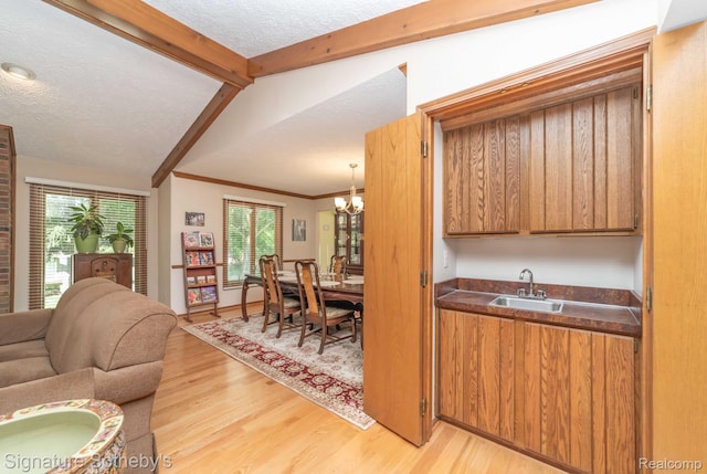 25759 Hunt Club Blvd, Farmington, MI 48335 - kitchen with light wood-style floors, dark countertops, a textured ceiling, brown cabinets, and open floor plan