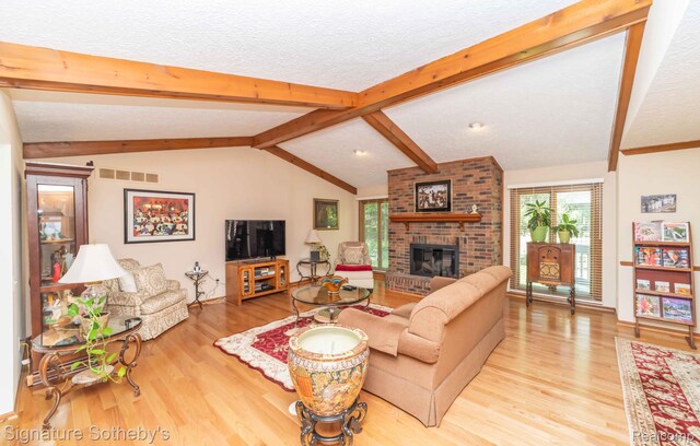 25759 Hunt Club Blvd, Farmington, MI 48335 - living area with wood finished floors, a brick fireplace, and a textured ceiling