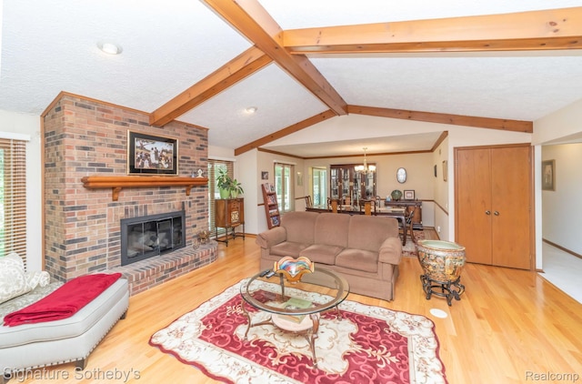 25759 Hunt Club Blvd, Farmington, MI 48335 - living area with wood finished floors, a brick fireplace, and a chandelier