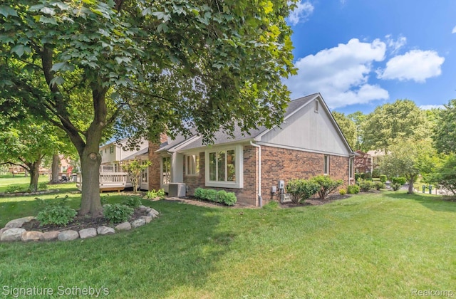25759 Hunt Club Blvd, Farmington, MI 48335 - view of front facade with brick siding, a front yard, and a wooden deck
