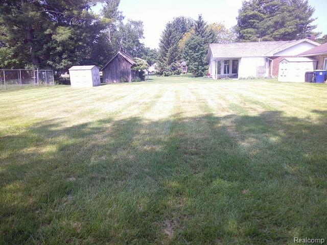 7776 Ash St, Birch Run, MI 48415 - view of yard with a storage unit