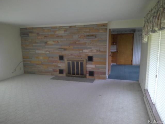 7776 Ash St, Birch Run, MI 48415 - unfurnished living room with carpet and a stone fireplace