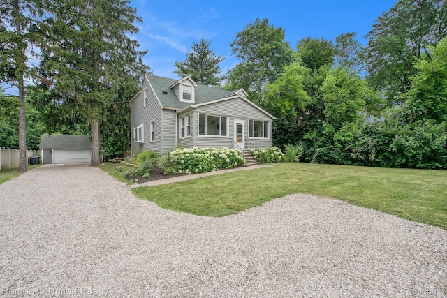 9309 Newburgh Rd, Livonia, MI 48150 - view of front of house featuring an outbuilding, a front lawn, a detached garage, and a shingled roof
