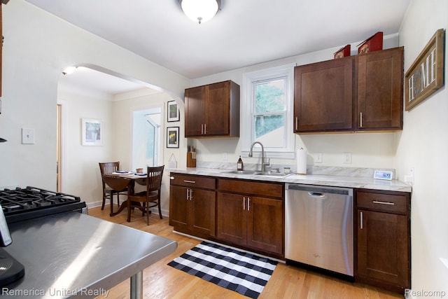 9309 Newburgh Rd, Livonia, MI 48150 - kitchen with dishwasher, arched walkways, light wood finished floors, light countertops, and dark brown cabinetry