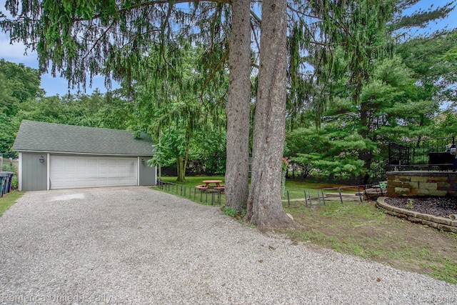 9309 Newburgh Rd, Livonia, MI 48150 - view of front facade with gravel driveway, a garage, and a shingled roof