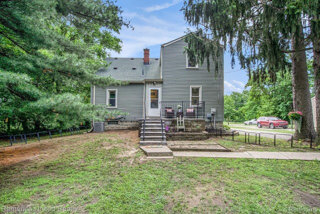 9309 Newburgh Rd, Livonia, MI 48150 - back of property featuring a chimney and a shingled roof
