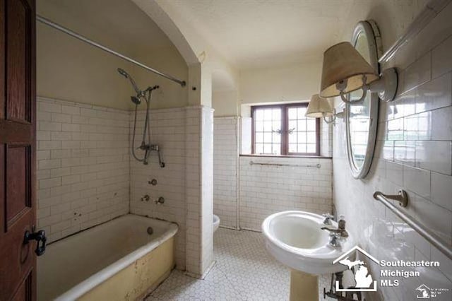 1989 W Grand Blvd, Detroit, MI 48208 - bathroom featuring tile walls, tile patterned floors, and shower / tub combination