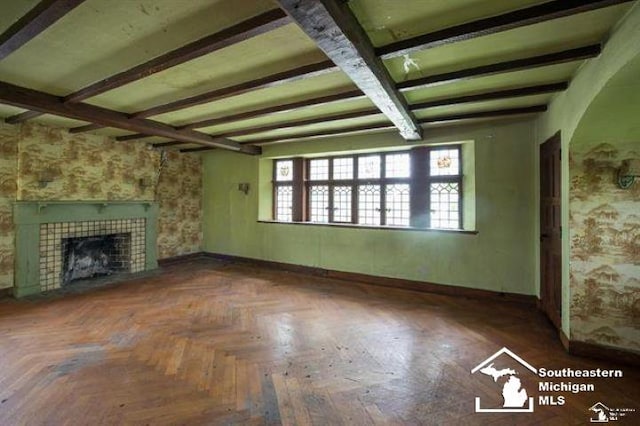 1989 W Grand Blvd, Detroit, MI 48208 - unfurnished living room featuring beam ceiling and a tiled fireplace