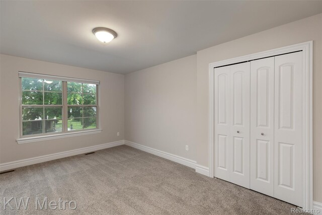 85 Hickory Dr, Troy, MI 48083 - unfurnished bedroom featuring carpet flooring and a closet