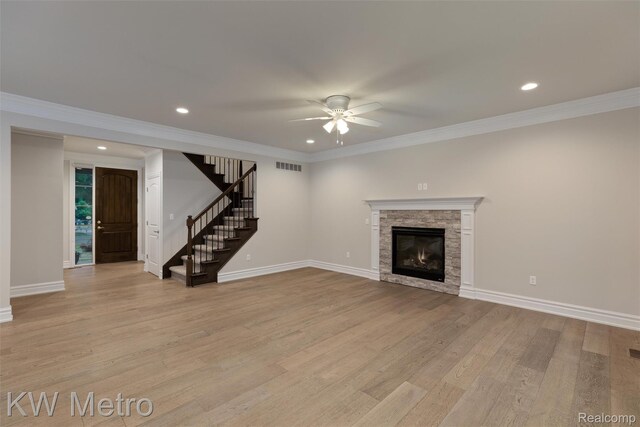 85 Hickory Dr, Troy, MI 48083 - unfurnished living room featuring a ceiling fan, recessed lighting, light wood finished floors, stairs, and a stone fireplace