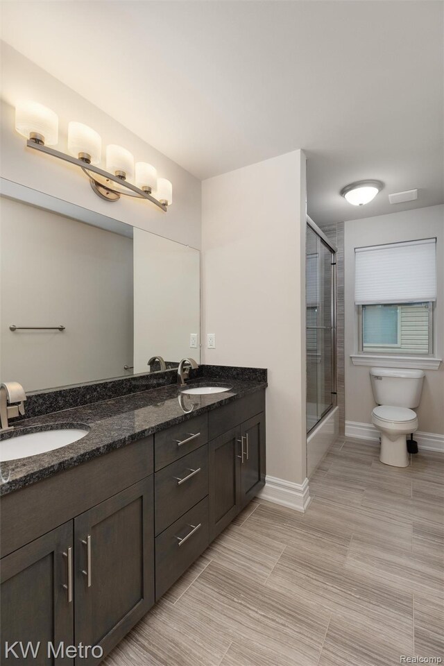 85 Hickory Dr, Troy, MI 48083 - full bathroom featuring double vanity, tile patterned flooring, and shower / bath combination with glass door