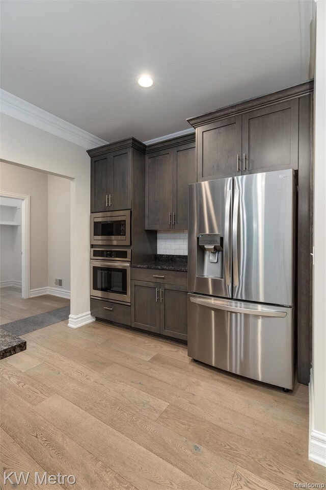 85 Hickory Dr, Troy, MI 48083 - kitchen featuring appliances with stainless steel finishes, crown molding, dark brown cabinetry, light wood-type flooring, and backsplash