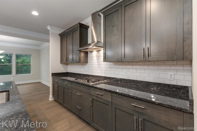 85 Hickory Dr, Troy, MI 48083 - kitchen with wall chimney exhaust hood, stainless steel gas stovetop, light wood finished floors, ornamental molding, and dark brown cabinets