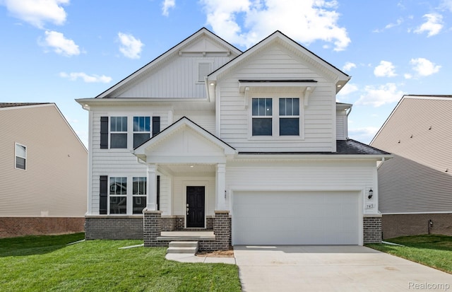 873 Risdon Trl S, Saline, MI 48176 - craftsman house with driveway, an attached garage, brick siding, and a front lawn
