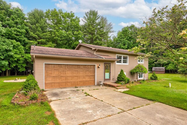 5852 Pinkerton Rd, Vassar, MI 48768 - split level home with a front lawn, an attached garage, and driveway