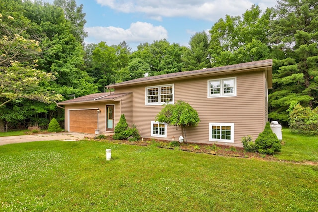 5852 Pinkerton Rd, Vassar, MI 48768 - split level home with an attached garage, driveway, and a front lawn