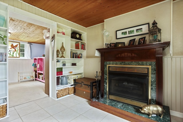 5852 Pinkerton Rd, Vassar, MI 48768 - living area featuring wooden ceiling, a wainscoted wall, a premium fireplace, tile patterned flooring, and wood walls