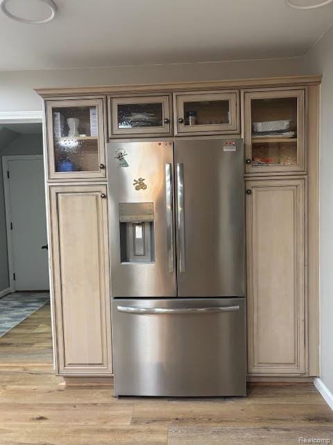 171 Golfview Dr, Caro, MI 48723 - kitchen featuring stainless steel fridge, light wood-type flooring, and glass insert cabinets