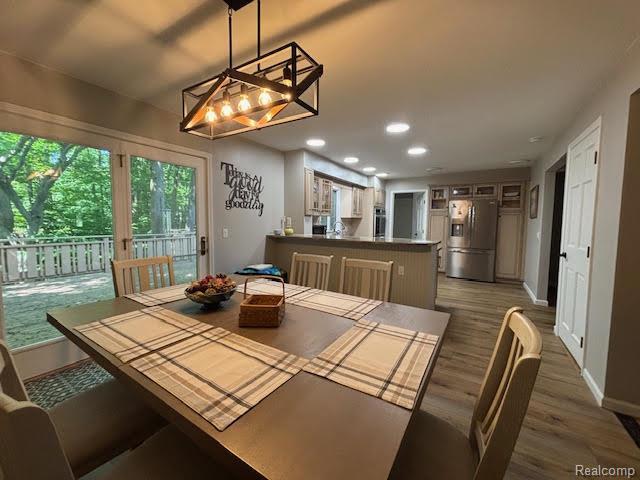 171 Golfview Dr, Caro, MI 48723 - dining room with a chandelier, wood finished floors, and recessed lighting