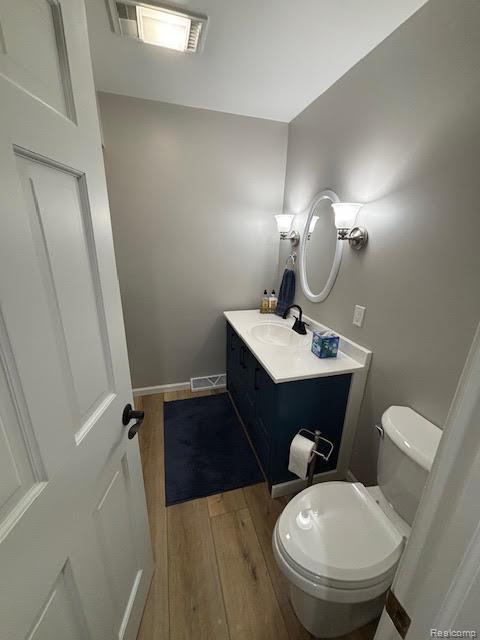 171 Golfview Dr, Caro, MI 48723 - half bathroom featuring wood finished floors and vanity