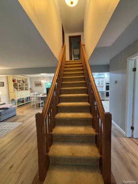 171 Golfview Dr, Caro, MI 48723 - staircase with wood finished floors and a high ceiling