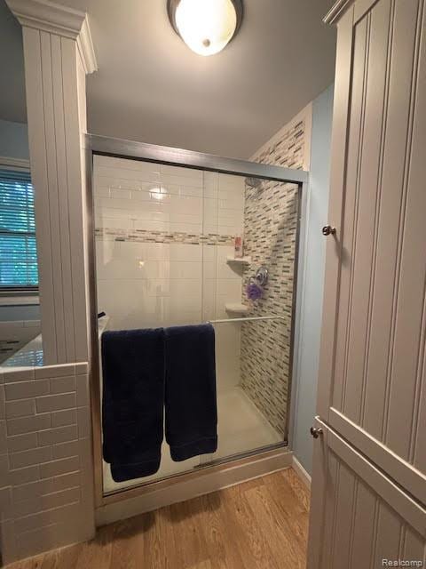 171 Golfview Dr, Caro, MI 48723 - bathroom featuring a stall shower and wood finished floors