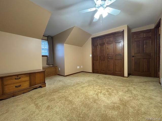 171 Golfview Dr, Caro, MI 48723 - unfurnished bedroom featuring light carpet, vaulted ceiling, a closet, and ceiling fan